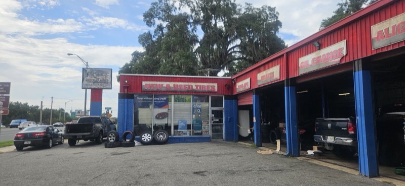 Florida Tires storefront with New & Used Tires signage and tires stacked out front